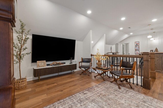 living room with vaulted ceiling, light wood-type flooring, baseboards, and recessed lighting