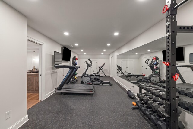 exercise room with recessed lighting and baseboards