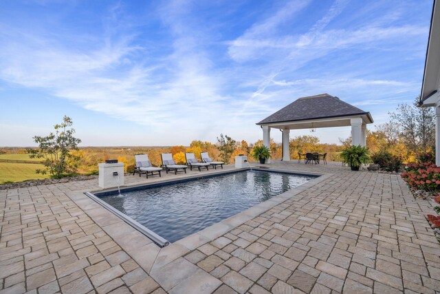 outdoor pool featuring a patio area and a gazebo