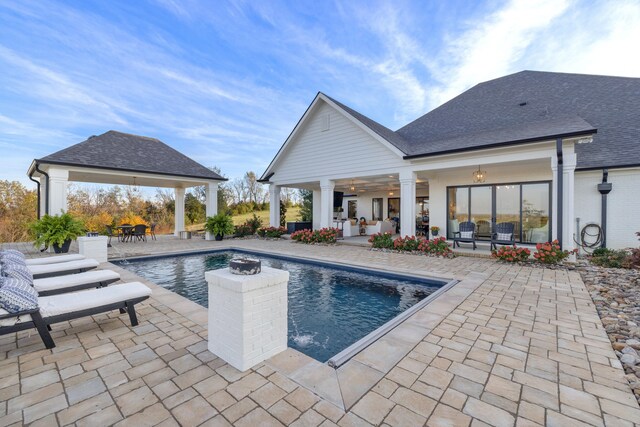 outdoor pool with a patio area and a gazebo