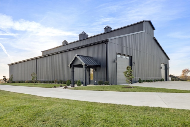 view of building exterior with a pole building and driveway