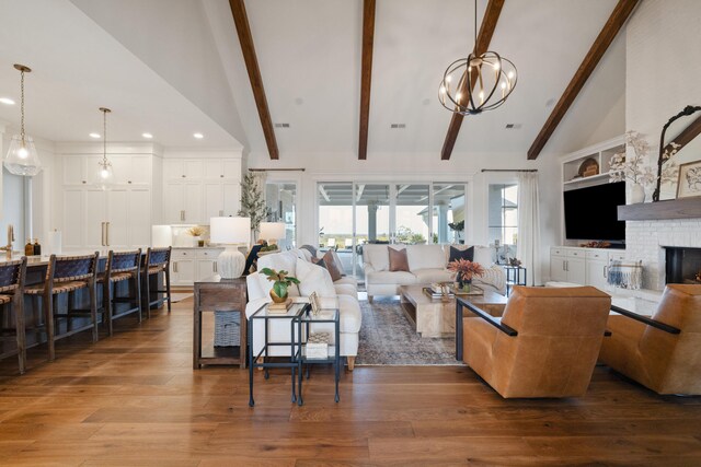 living area featuring a fireplace, wood finished floors, beam ceiling, and recessed lighting