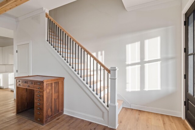 stairway with baseboards and wood finished floors