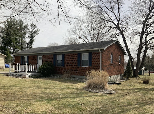 single story home with brick siding, crawl space, a front yard, and a wooden deck