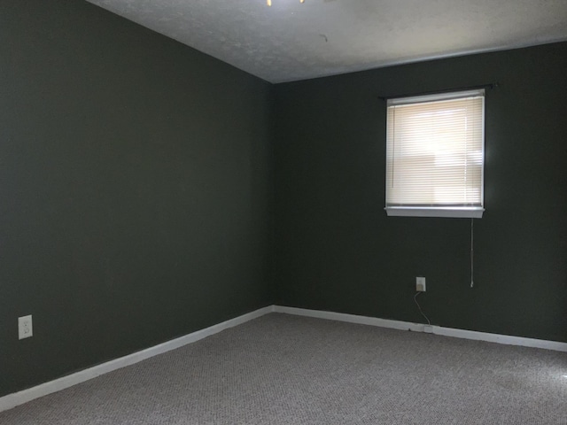 empty room with carpet flooring and baseboards