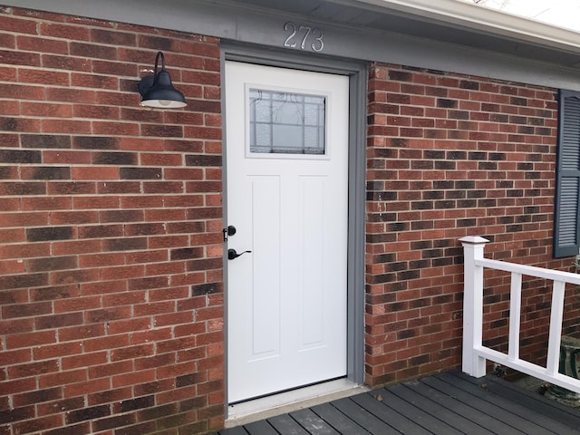 entrance to property with brick siding