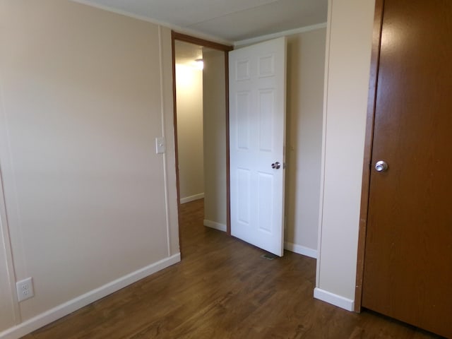 unfurnished bedroom featuring baseboards and wood finished floors