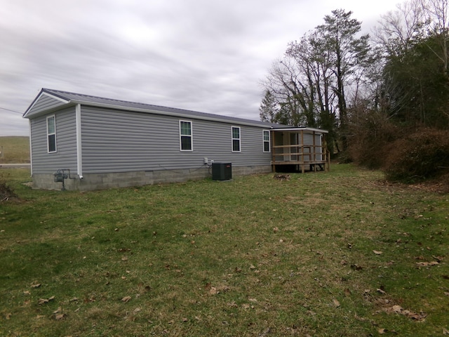 view of home's exterior with central air condition unit, crawl space, a lawn, and a wooden deck