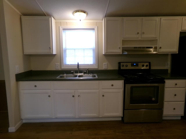 kitchen with under cabinet range hood, electric range, a sink, white cabinetry, and dark countertops