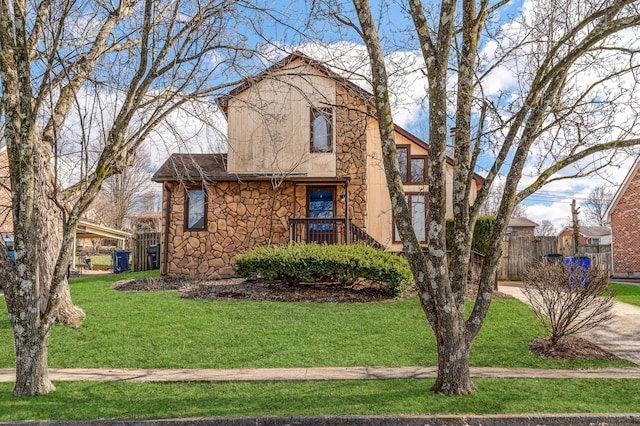 view of front of house with stone siding, fence, a front lawn, and stucco siding