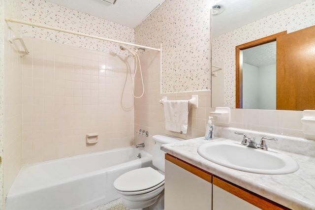 full bathroom featuring tile walls, toilet, washtub / shower combination, a textured ceiling, and wallpapered walls