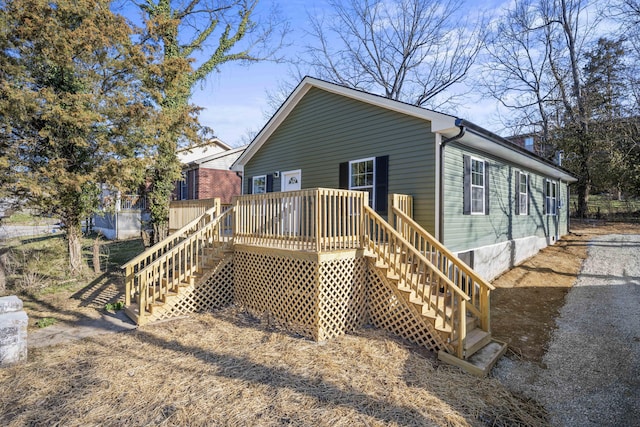 back of property featuring a deck and stairway