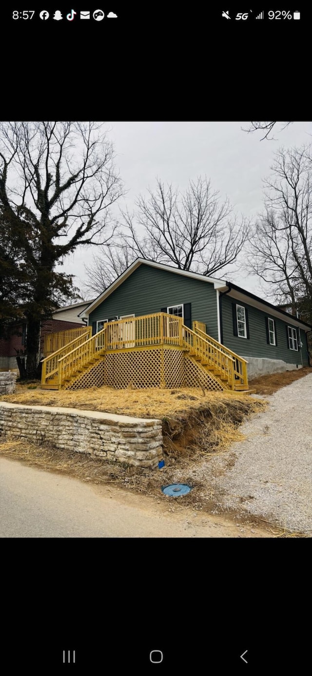 view of front of house featuring a deck and stairway