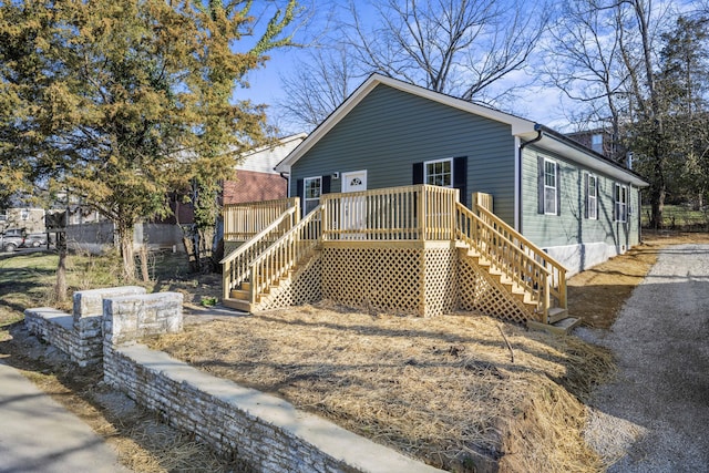 view of front of property with a wooden deck and stairway