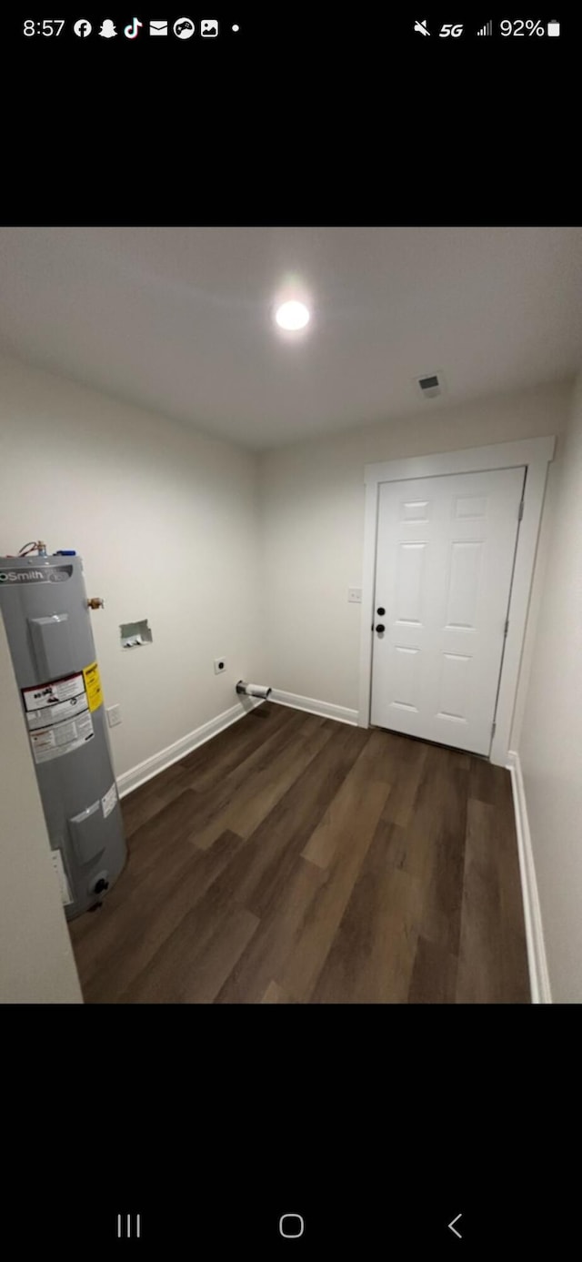 laundry area with recessed lighting, visible vents, baseboards, water heater, and dark wood finished floors