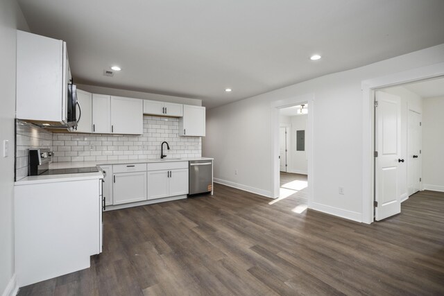 unfurnished living room featuring ceiling fan, baseboards, and dark wood finished floors