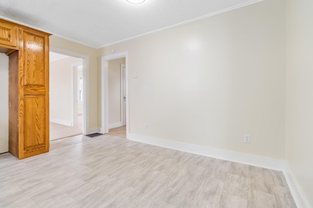 empty room with baseboards and ornamental molding