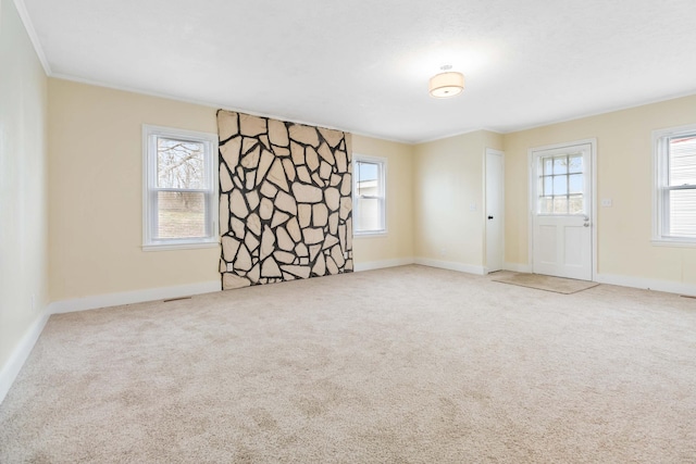 empty room with plenty of natural light, carpet flooring, and baseboards