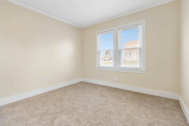 unfurnished room featuring baseboards, ornamental molding, and light colored carpet