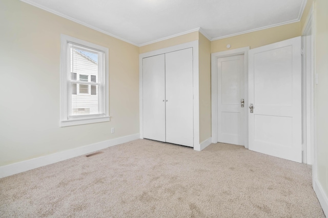 unfurnished bedroom with ornamental molding, carpet flooring, and visible vents