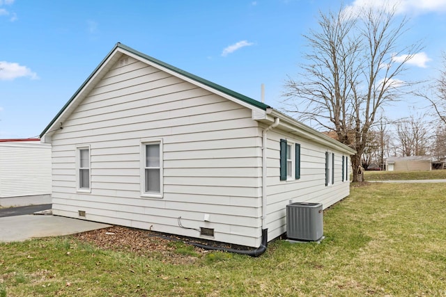 view of side of property featuring crawl space, a patio area, a yard, and central AC