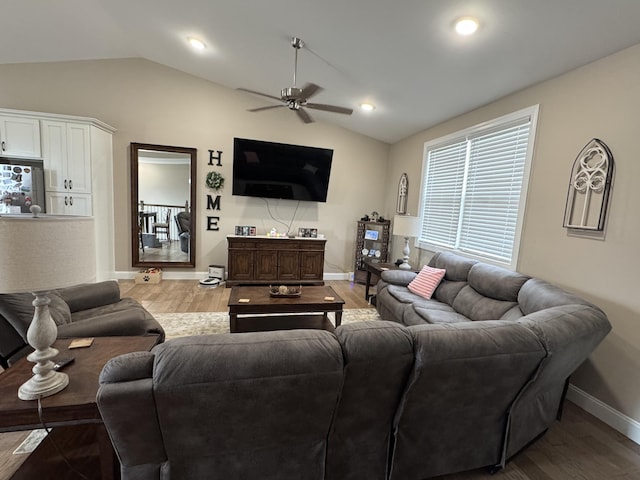 living room with lofted ceiling, baseboards, a ceiling fan, and wood finished floors