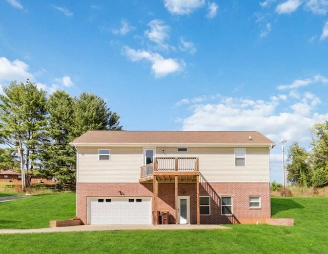 back of property featuring a garage, a yard, brick siding, and a wooden deck