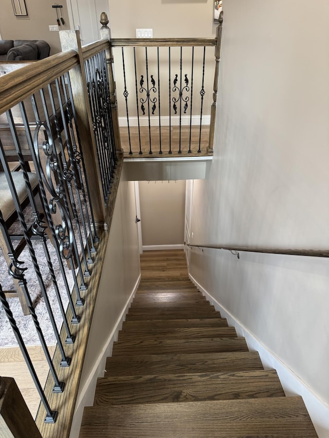 stairs with baseboards and wood finished floors