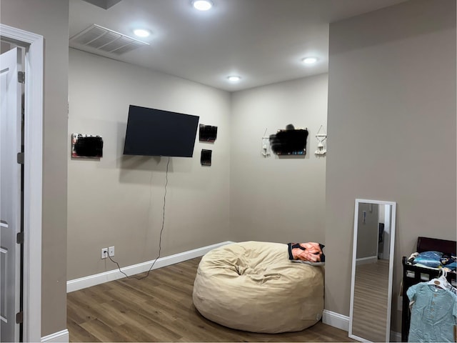 interior space with recessed lighting, wood finished floors, visible vents, and baseboards