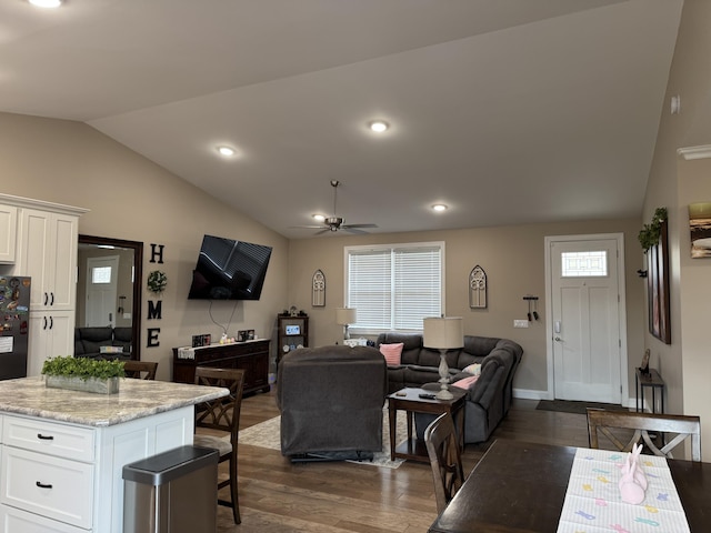 interior space featuring dark wood-style floors, a healthy amount of sunlight, vaulted ceiling, and ceiling fan