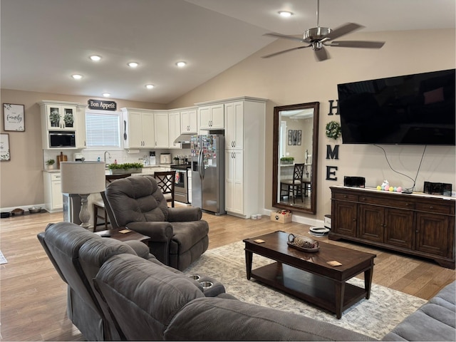 living area featuring lofted ceiling, recessed lighting, a ceiling fan, baseboards, and light wood finished floors