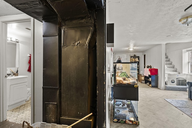 interior space with stairway and a textured ceiling