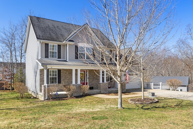 view of front of property featuring a front lawn, a porch, roof with shingles, concrete driveway, and an attached garage