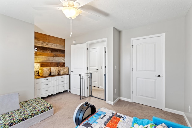 bedroom featuring carpet flooring, ceiling fan, a textured ceiling, and baseboards