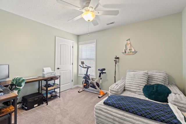 carpeted bedroom with baseboards, visible vents, a textured ceiling, and a ceiling fan