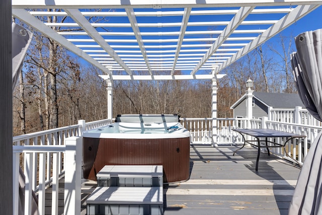 wooden deck with a pergola and a hot tub