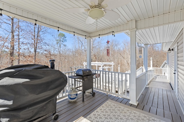 deck with grilling area and ceiling fan