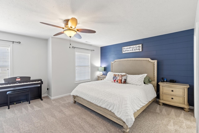 bedroom featuring baseboards, carpet, ceiling fan, and a textured ceiling