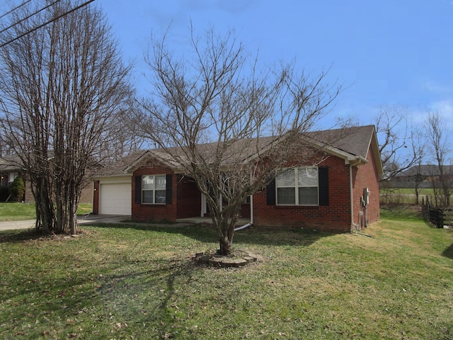 ranch-style house with driveway, brick siding, an attached garage, and a front yard