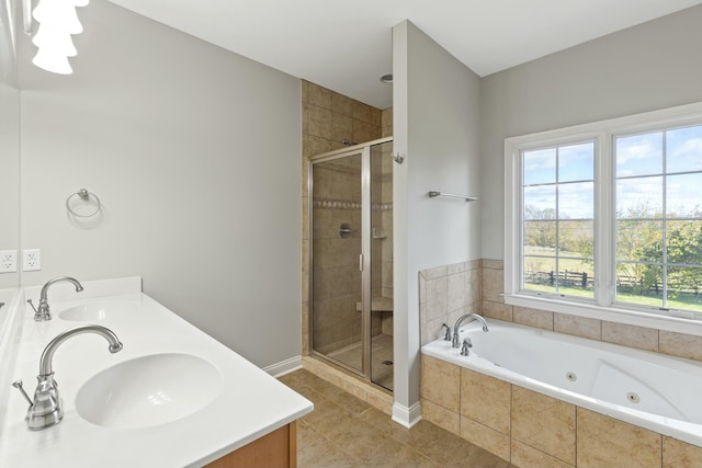 bathroom featuring double vanity, a stall shower, a sink, and a jetted tub