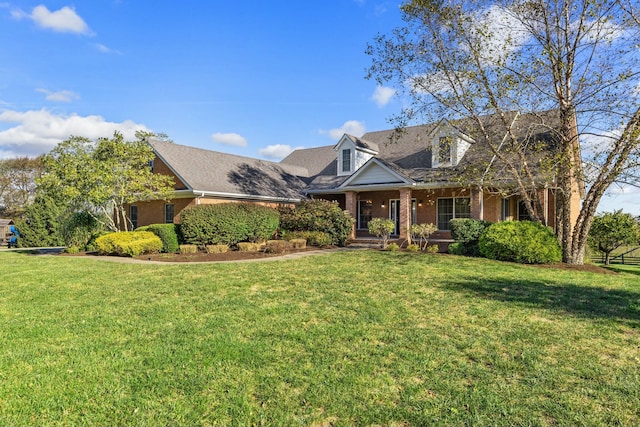 view of front of home with brick siding and a front lawn