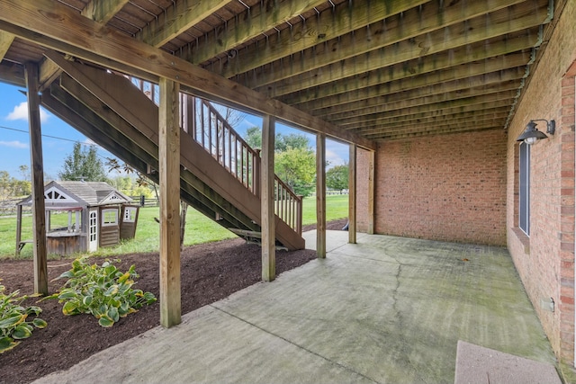 view of patio / terrace with an outbuilding and stairs