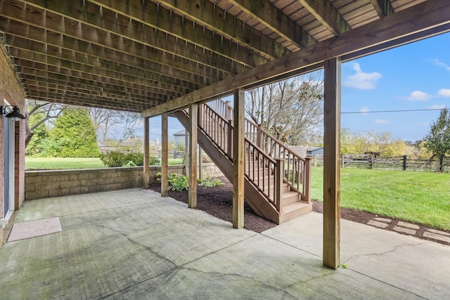 view of patio / terrace with fence and stairway