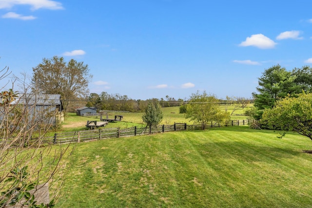 view of yard featuring a rural view and fence