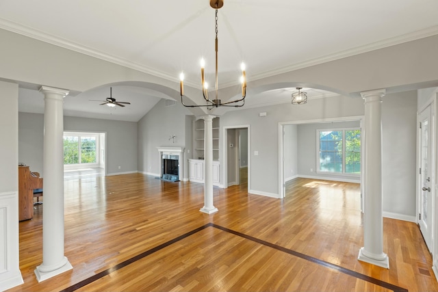 unfurnished living room featuring ceiling fan, light wood-style flooring, a fireplace with flush hearth, and decorative columns