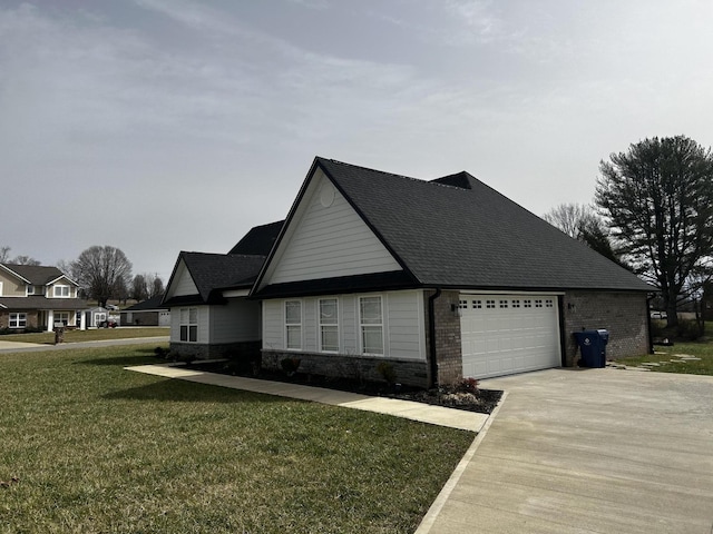 view of property exterior featuring concrete driveway, brick siding, a yard, and an attached garage