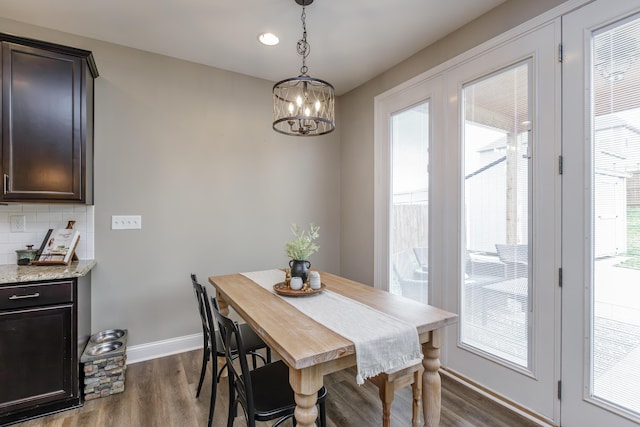 dining area with baseboards, dark wood finished floors, and a wealth of natural light