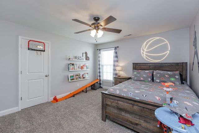 carpeted bedroom with visible vents, ceiling fan, and baseboards