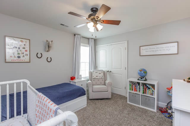 bedroom with carpet, visible vents, and ceiling fan