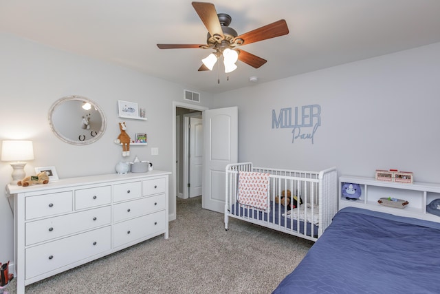 bedroom with light colored carpet, visible vents, and ceiling fan